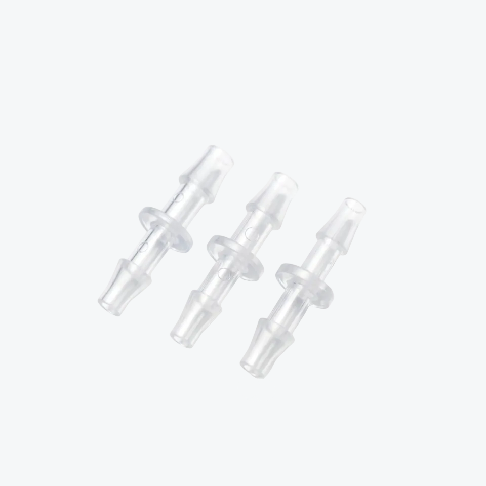 Three clear plastic connectors on a white background